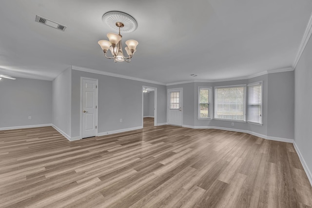 interior space featuring a chandelier, light hardwood / wood-style floors, and ornamental molding