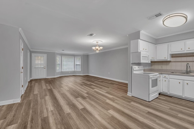 kitchen with white appliances, sink, a chandelier, white cabinets, and light hardwood / wood-style floors