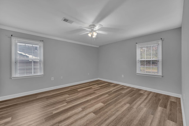 spare room with crown molding, hardwood / wood-style floors, and ceiling fan