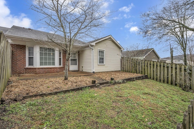 rear view of house featuring a lawn