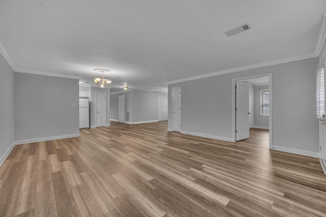 unfurnished living room with a chandelier, light hardwood / wood-style flooring, and crown molding