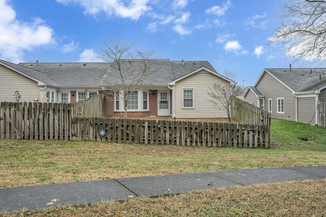 rear view of property with a lawn