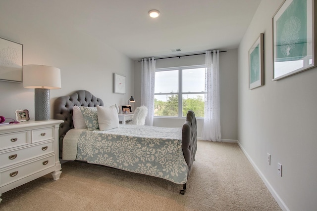 bedroom with light colored carpet