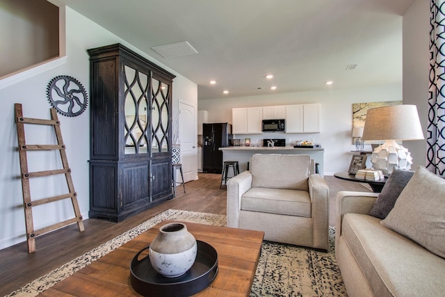 living room with dark hardwood / wood-style flooring