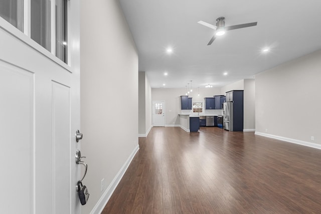 living room with ceiling fan and dark hardwood / wood-style flooring