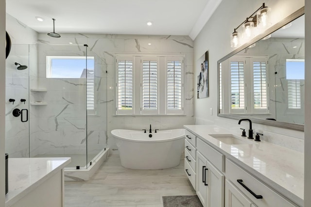 bathroom with vanity and independent shower and bath