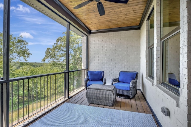 sunroom with ceiling fan and wooden ceiling