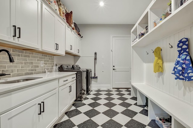 laundry room with cabinets, sink, and washer and dryer