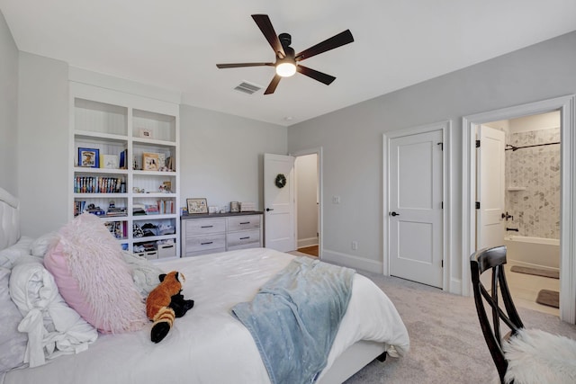 carpeted bedroom featuring ensuite bath and ceiling fan