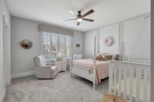 bedroom with ceiling fan and light colored carpet