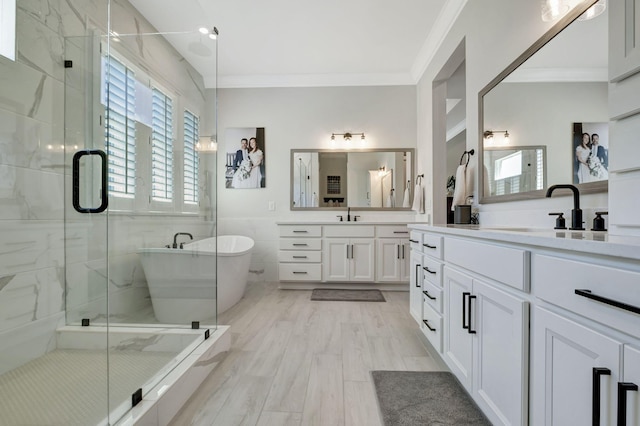 bathroom with vanity, hardwood / wood-style flooring, separate shower and tub, and crown molding