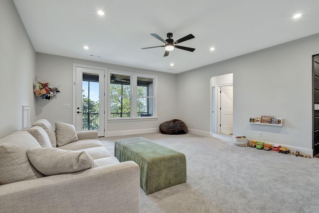 living room with light carpet and ceiling fan