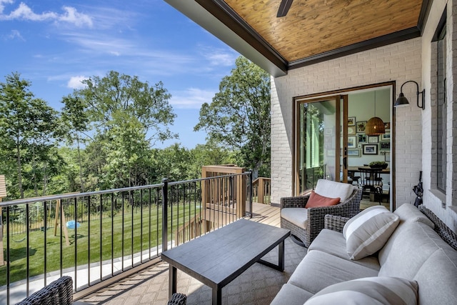 balcony with an outdoor living space and ceiling fan