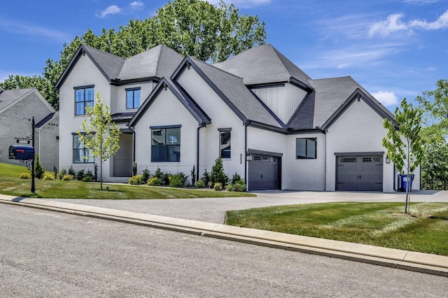 view of front of property with a front yard and a garage