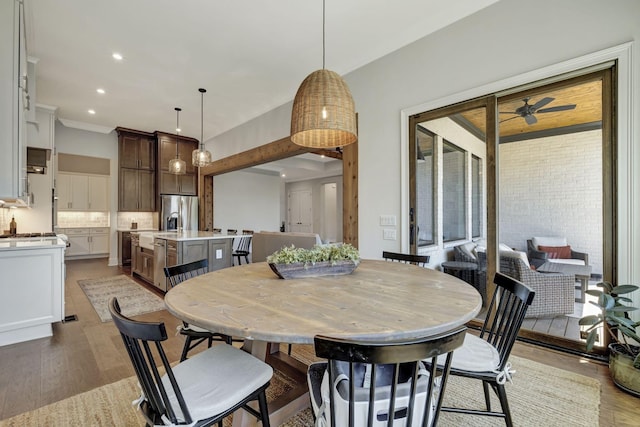 dining space featuring ceiling fan and light hardwood / wood-style flooring