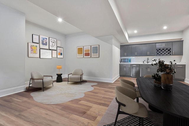 living area featuring wood-type flooring and sink