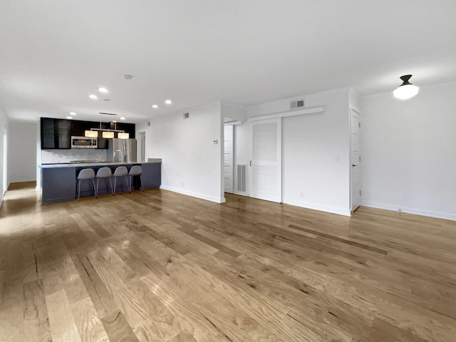 unfurnished living room with wood-type flooring