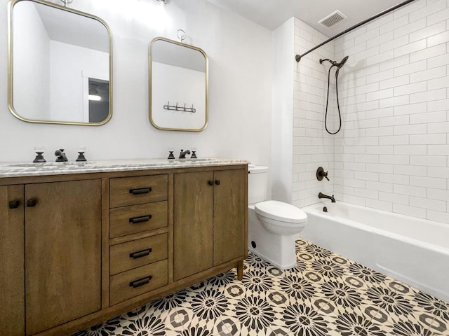 full bathroom with tile patterned flooring, vanity, toilet, and tiled shower / bath