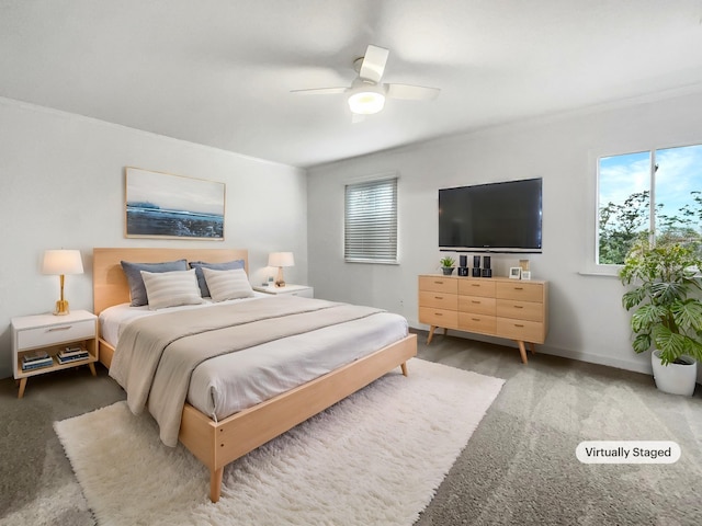 carpeted bedroom with multiple windows and ceiling fan