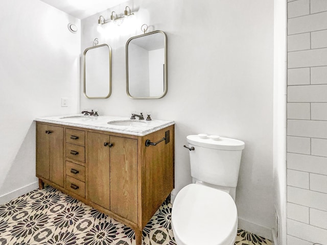 bathroom featuring tile patterned floors, vanity, and toilet