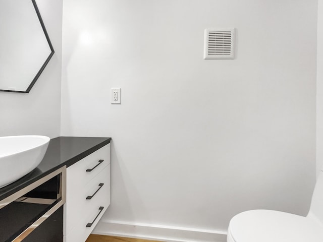 bathroom featuring vanity and toilet