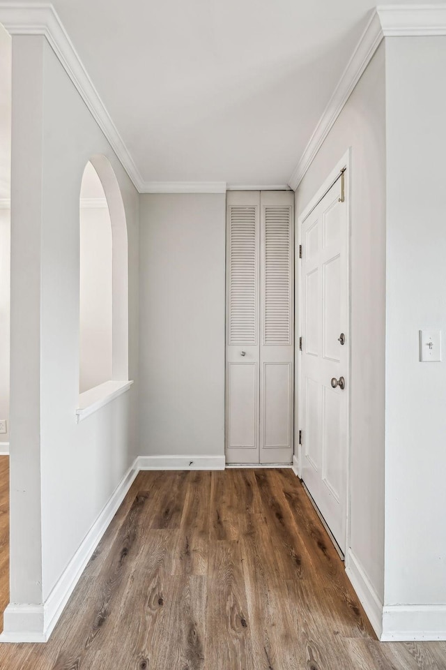 interior space with crown molding and dark wood-type flooring