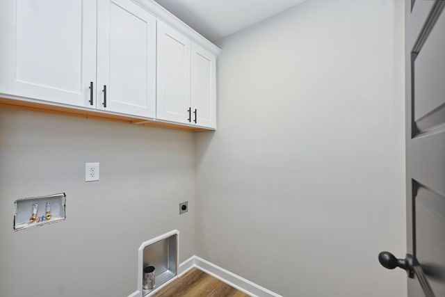 laundry area featuring electric dryer hookup, cabinets, dark wood-type flooring, and hookup for a washing machine