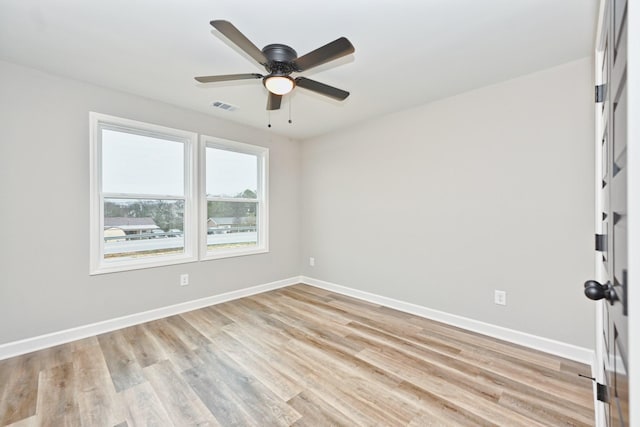 unfurnished room featuring ceiling fan and light wood-type flooring