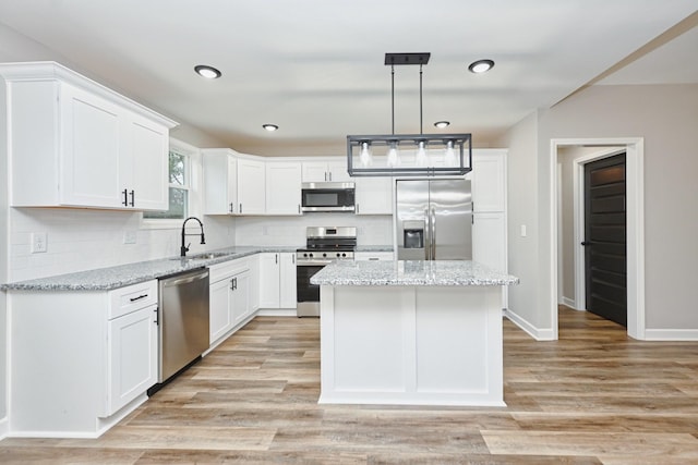 kitchen featuring white cabinets, appliances with stainless steel finishes, and a kitchen island