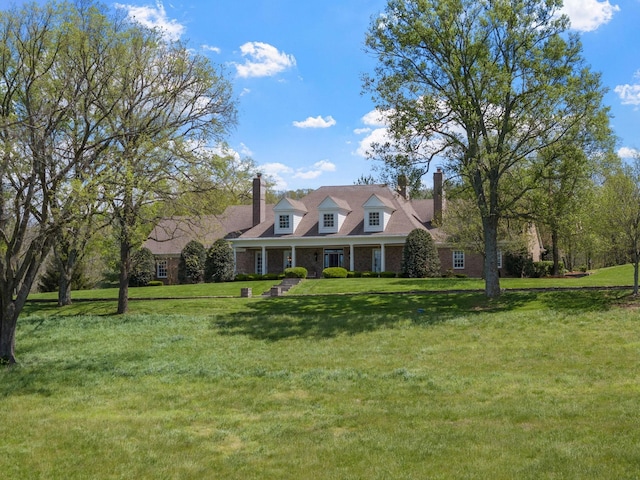 cape cod-style house with a front lawn