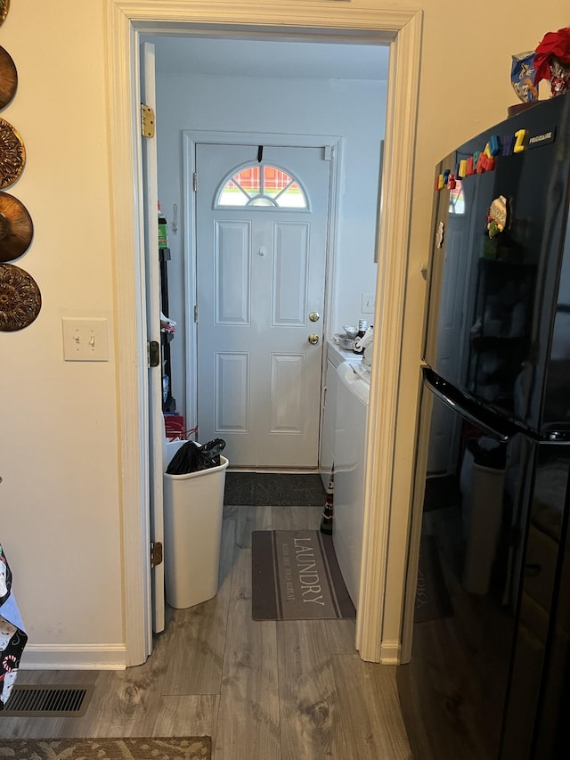 entryway with washer and clothes dryer and hardwood / wood-style flooring