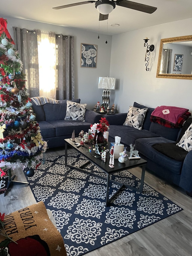 living room featuring hardwood / wood-style floors and ceiling fan