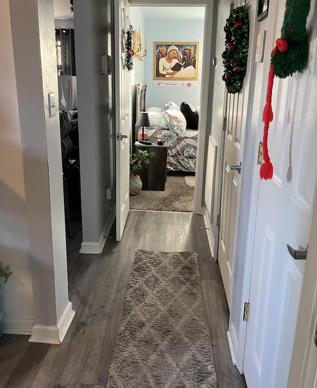 hallway featuring dark hardwood / wood-style flooring