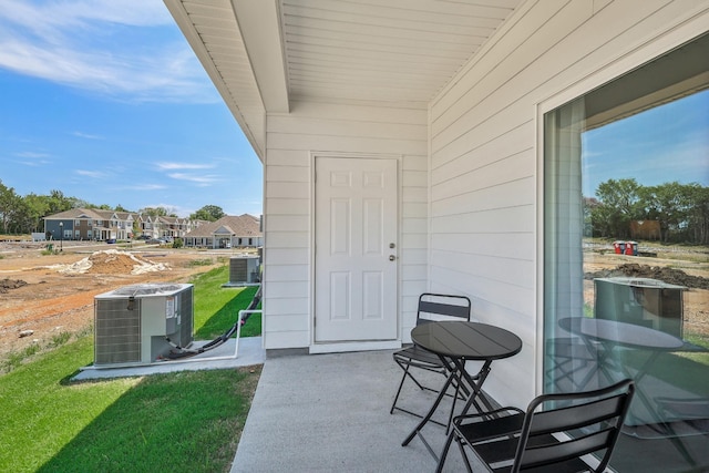 entrance to property with central AC unit and a patio