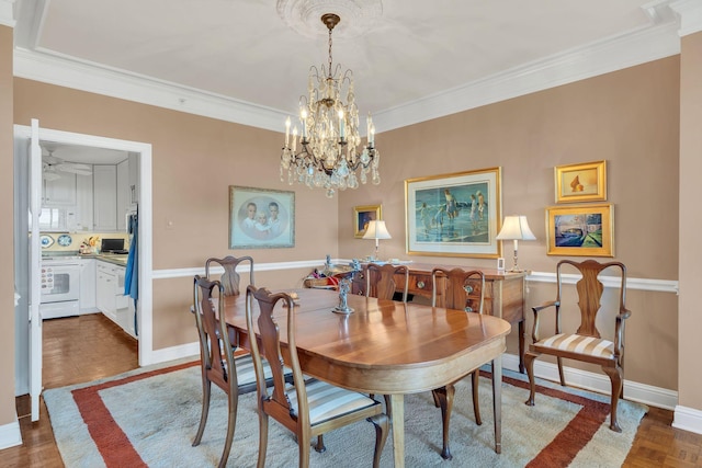 dining space with ceiling fan with notable chandelier and ornamental molding