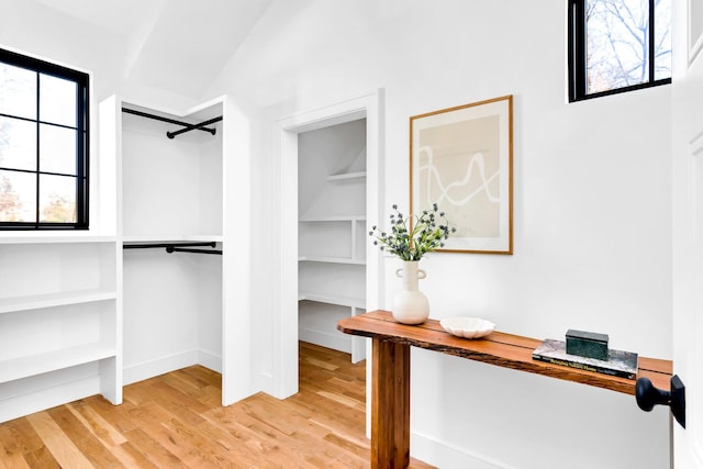 spacious closet featuring vaulted ceiling and light wood finished floors