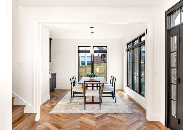 dining room featuring parquet flooring