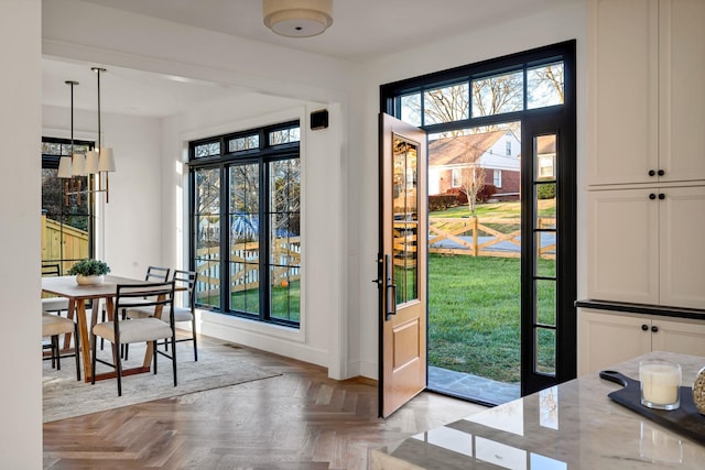 doorway with light parquet flooring