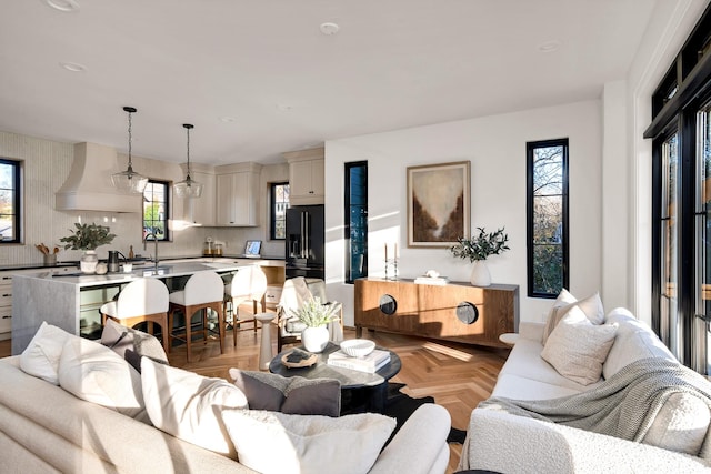 living room with light parquet floors and sink