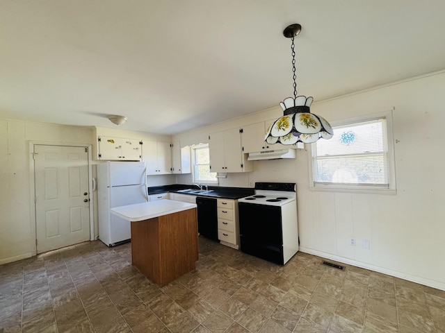 kitchen with a center island, white appliances, sink, decorative light fixtures, and white cabinetry