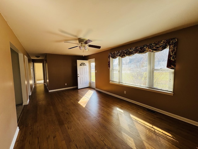 unfurnished room featuring ceiling fan and dark hardwood / wood-style floors