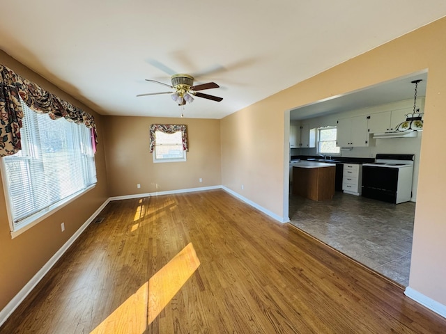 interior space with ceiling fan, sink, and light hardwood / wood-style floors