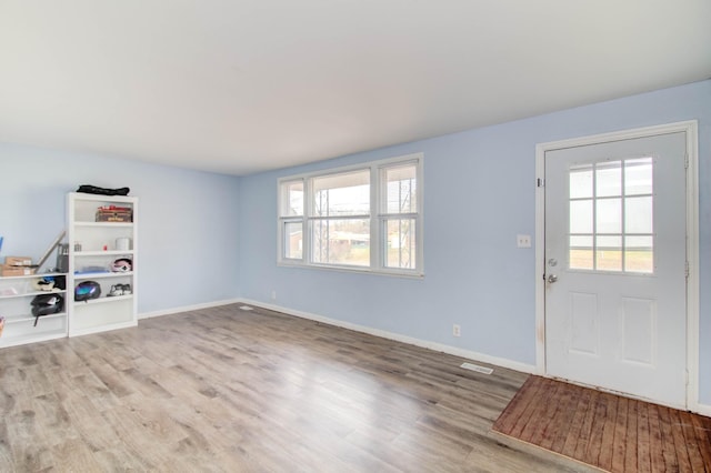 entryway with light hardwood / wood-style floors and a healthy amount of sunlight