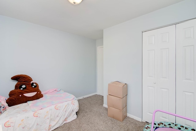 bedroom featuring a closet and light colored carpet