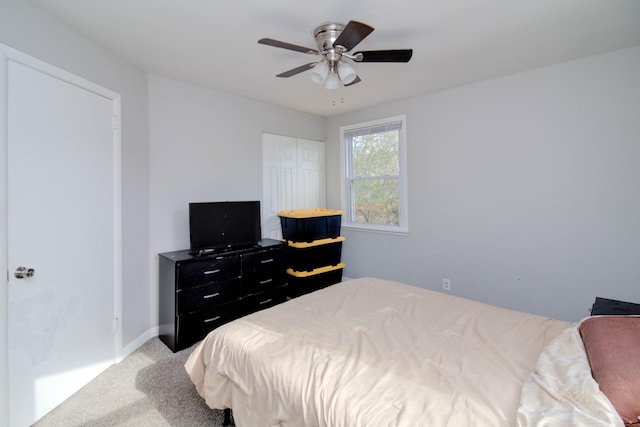 carpeted bedroom featuring a closet and ceiling fan