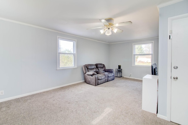 sitting room featuring ornamental molding, light carpet, and a wealth of natural light