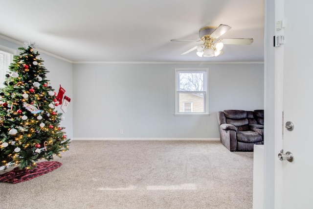 sitting room with light carpet, ceiling fan, and ornamental molding