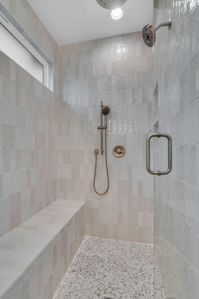 bathroom with a tile shower