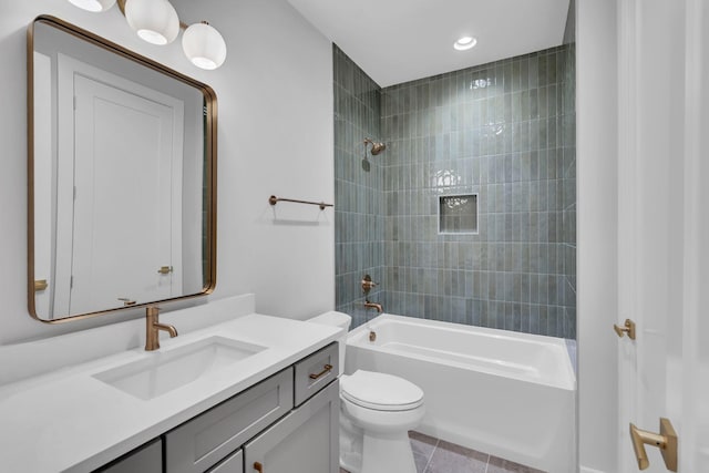 full bathroom with vanity, tiled shower / bath combo, toilet, and tile patterned flooring