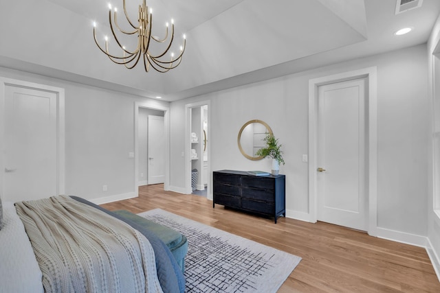 living room with hardwood / wood-style flooring and a notable chandelier